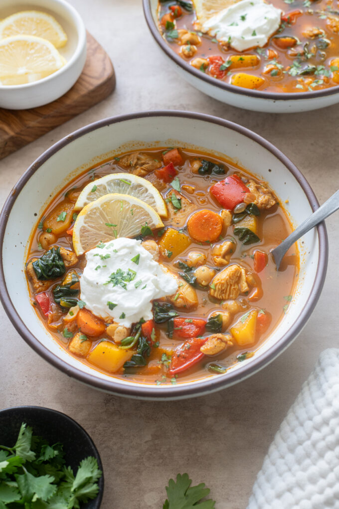 Moroccan chicken soup in a bowl with a dollop of Greek yogurt.