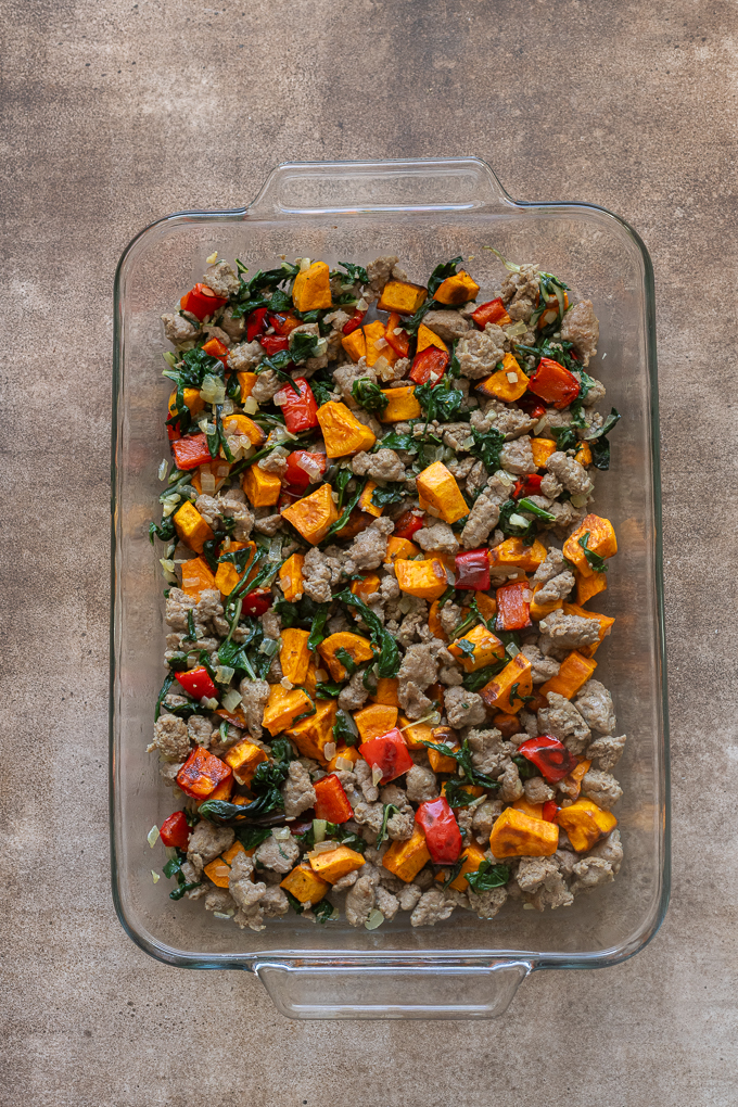 Filling for sausage and egg breakfast casserole in baking dish.