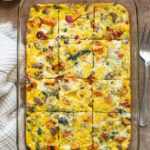 Sausage and egg breakfast casserole sliced in baking dish.
