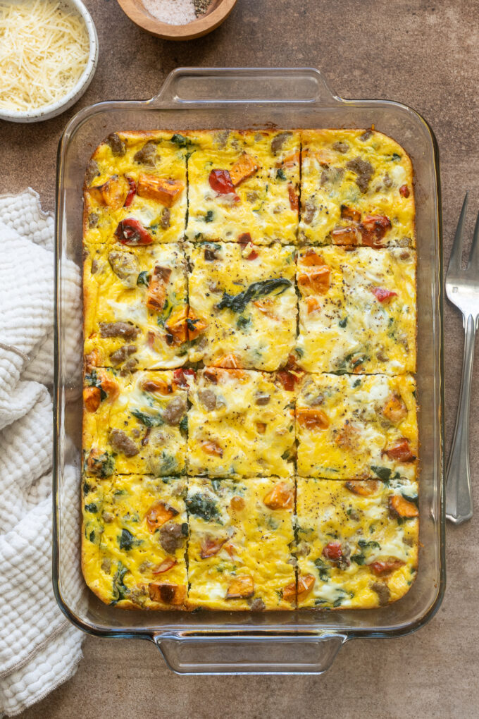 Sausage and egg breakfast casserole sliced in baking dish.