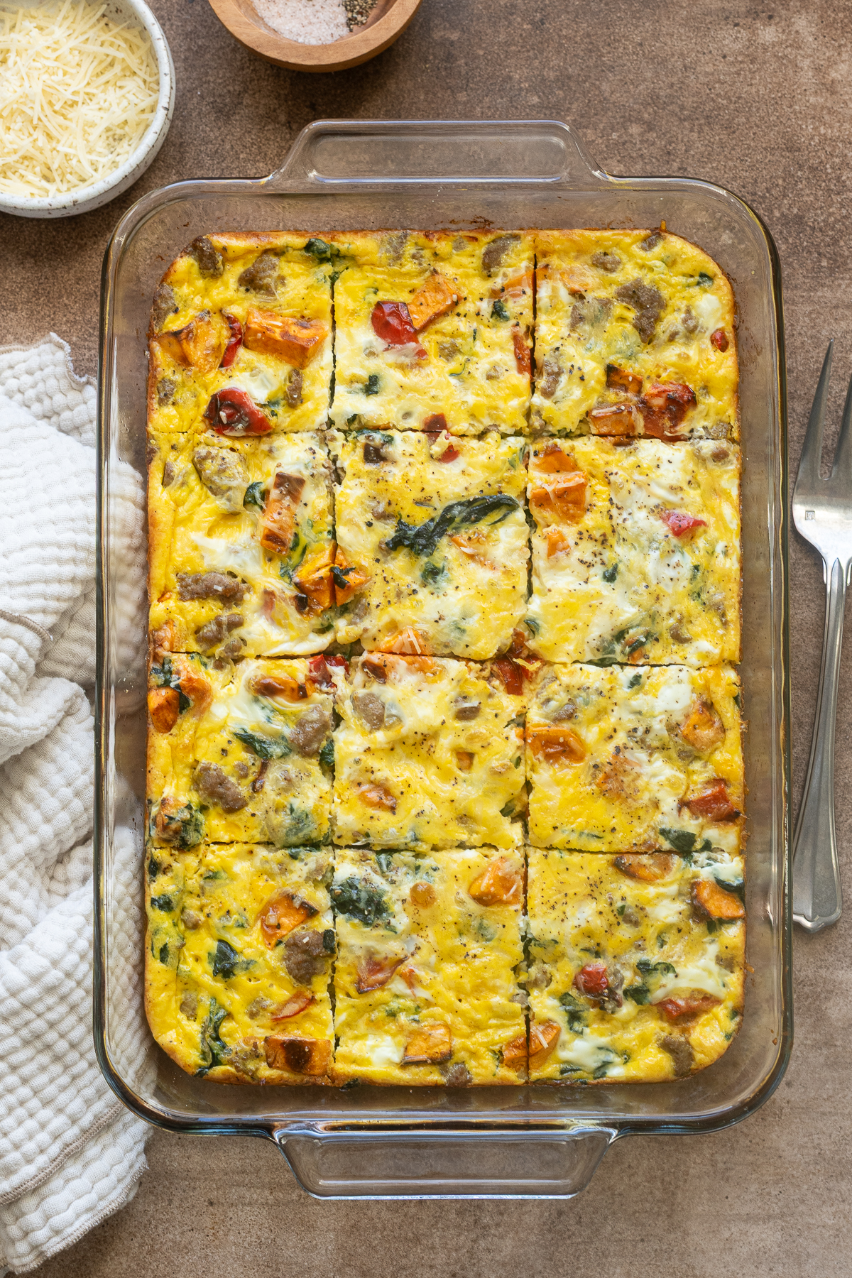 Sausage and egg breakfast casserole sliced in baking dish.