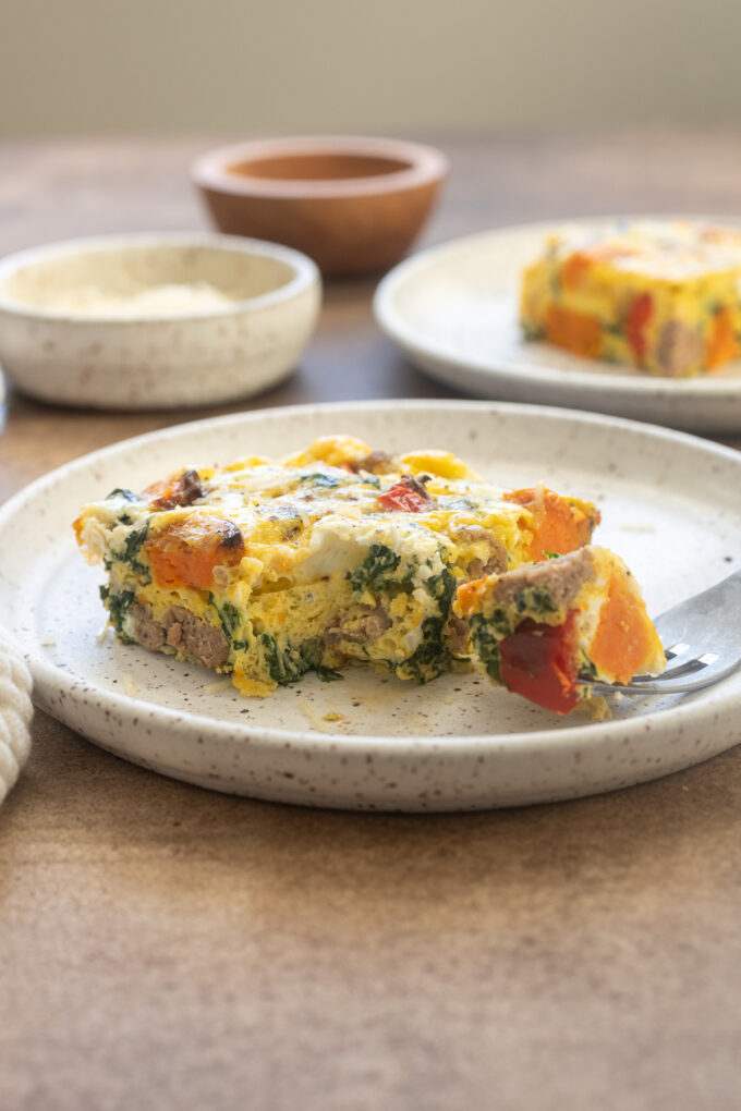 Slice of Sweet potato and sausage egg bake on a plate.