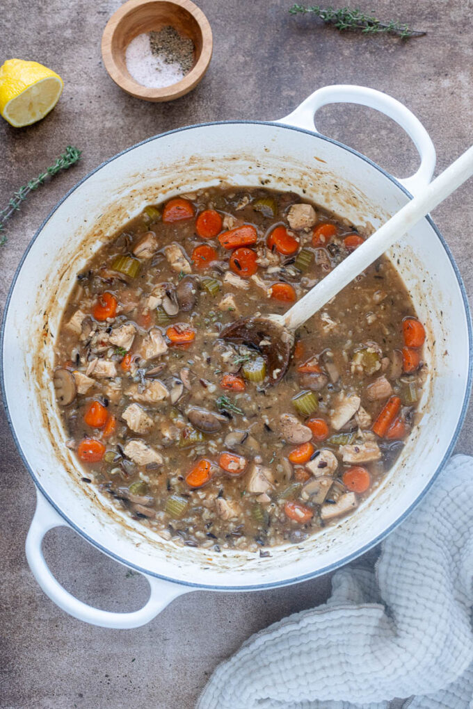 Chicken and wild rice soup in a Dutch oven.