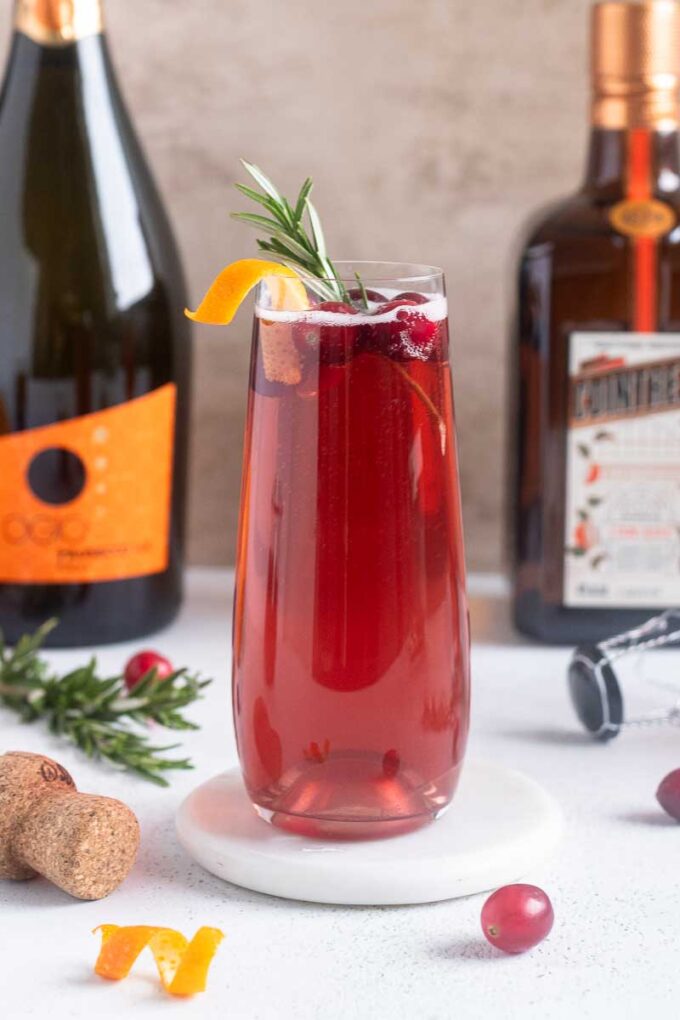 Christmas champagne cocktail with orange twist garnish.