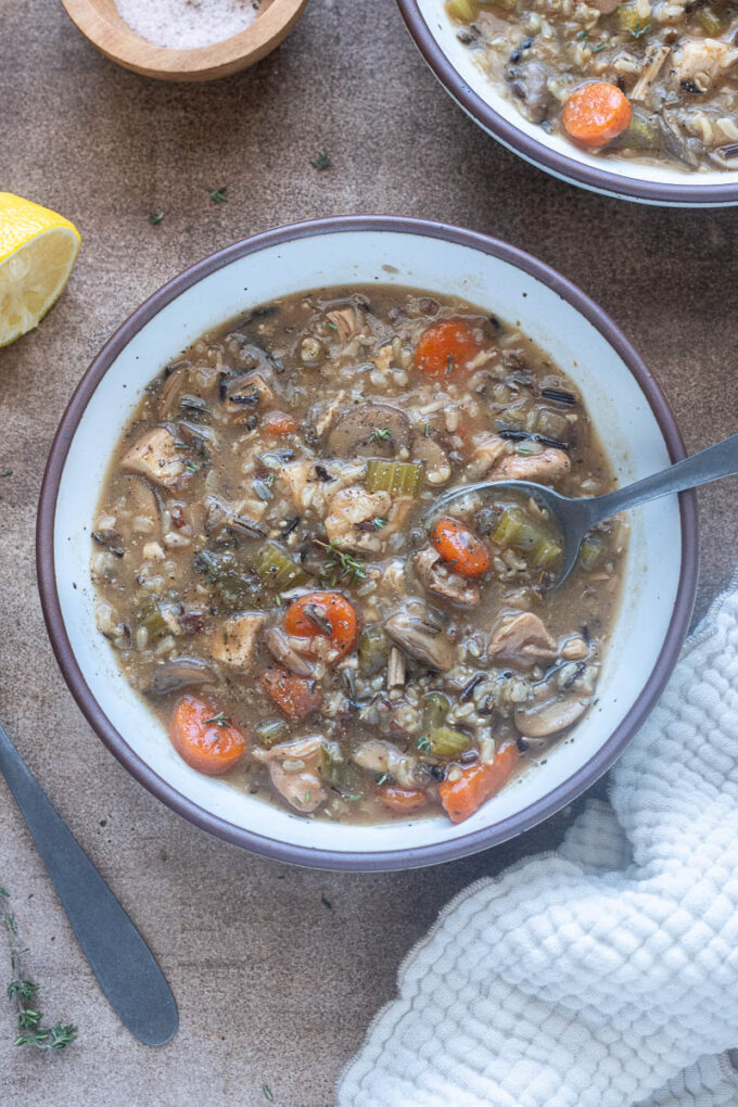 Dairy free chicken wild rice soup in a bowl with a spoon.