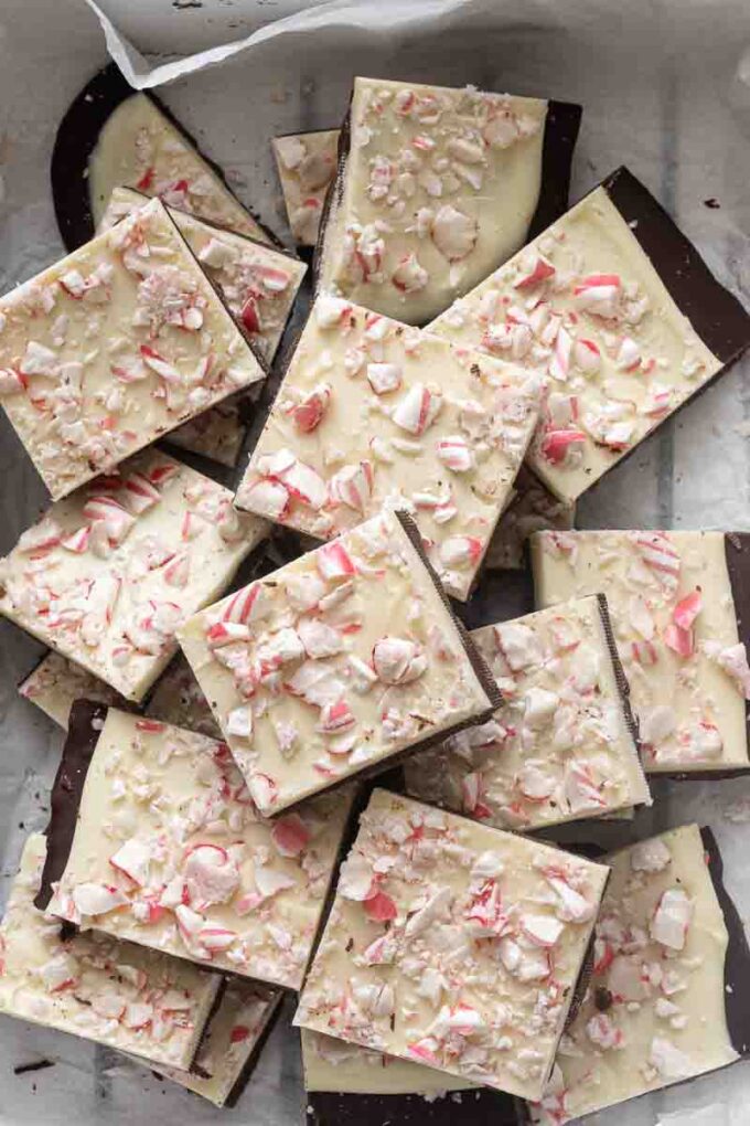 Squares of peppermint bark with layers of dark chocolate, white chocolate and peppermint.