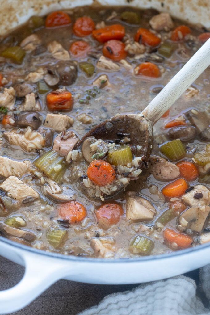 Stovetop chicken and wild rice soup in a Dutch oven.