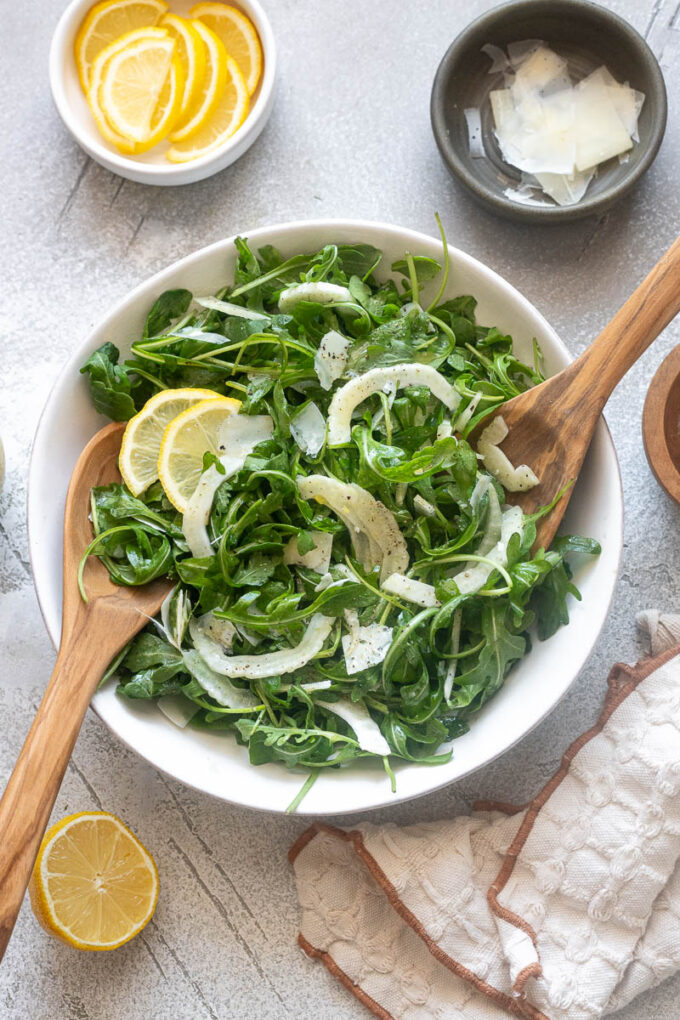 Fennel arugula salad tossed in a bowl.