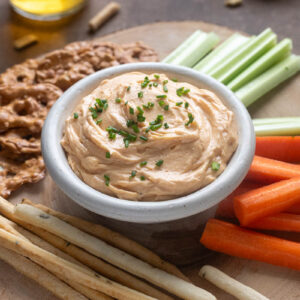 Homemade Cheddar Pub Cheese in a bowl topped with chives.
