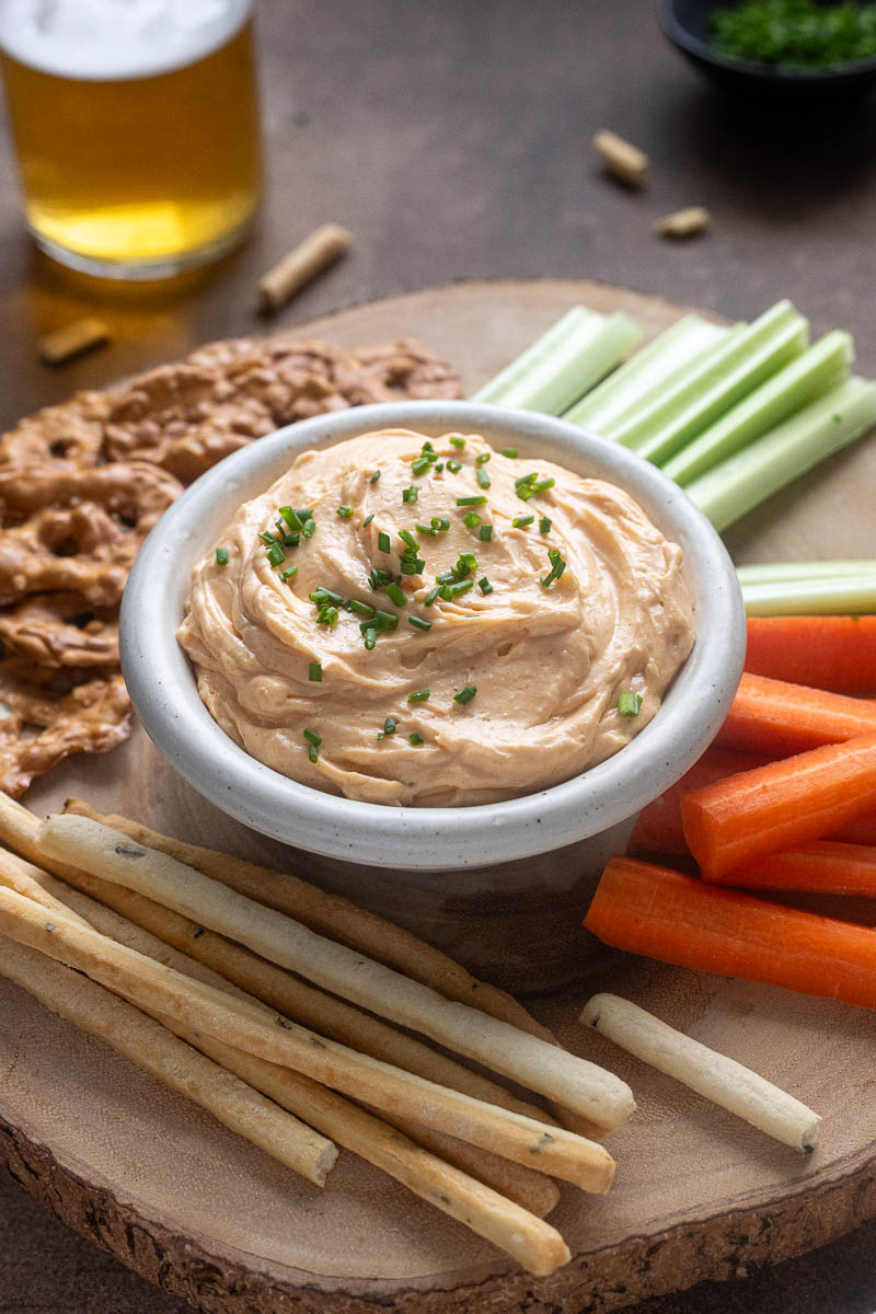 Homemade Cheddar Pub Cheese in a bowl topped with chives.