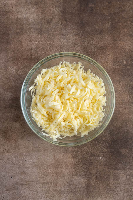 Grated white cheddar cheese for pub cheese.