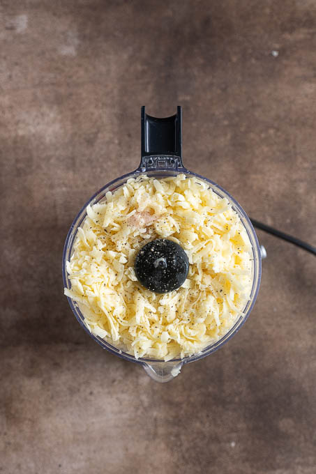 Pub cheese recipe ingredients in a food processor before processing.