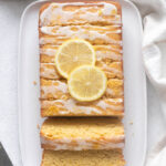 Almond flour lemon loaf cake sliced on a serving platter.