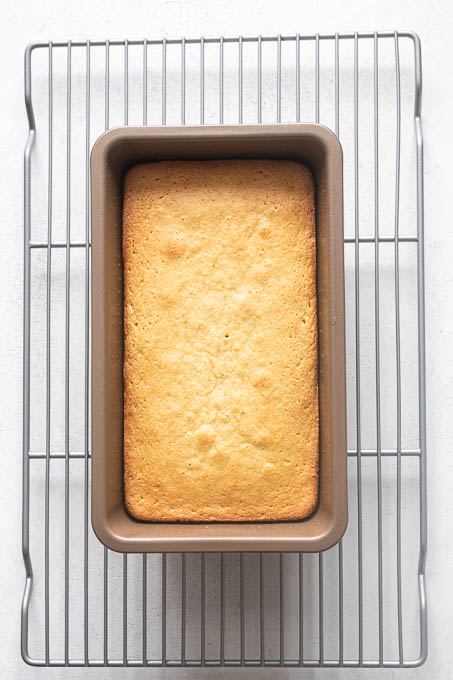 Baked almond flour lemon loaf cake on wire rack.