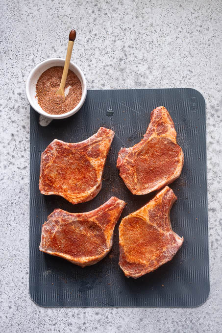 Season the pork chops with the sweet and smoky rub.