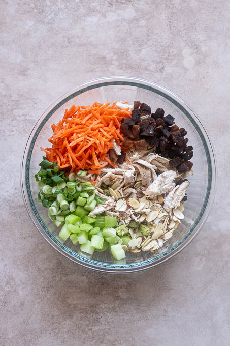 Curry chicken salad ingredients in mixing bowl.