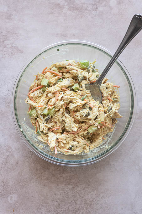 Finished curry chicken salad in a mixing bowl.
