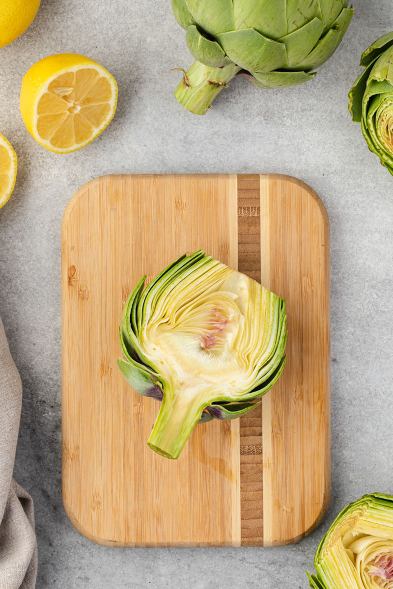 Halved artichoke showing fuzzy choke in the center.