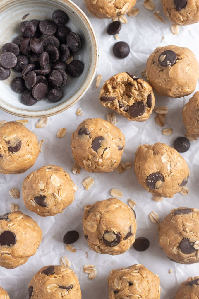 No-bake peanut butter protein balls on parchment paper.