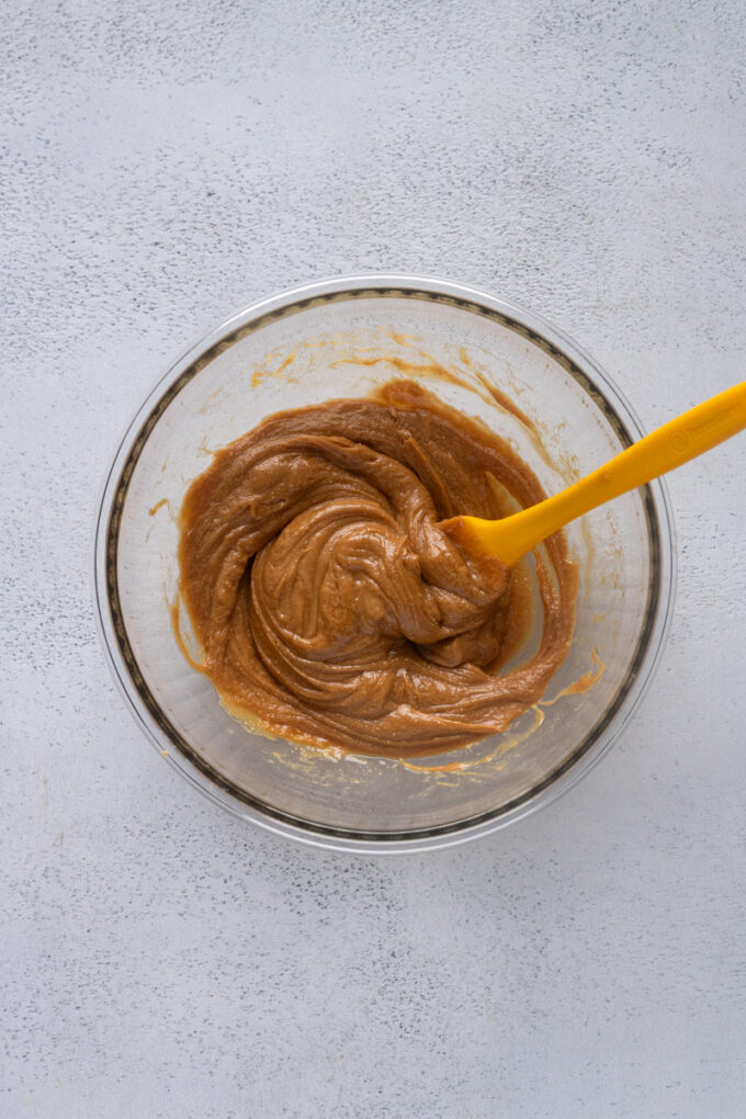 Peanut butter protein balls wet ingredients in bowl.