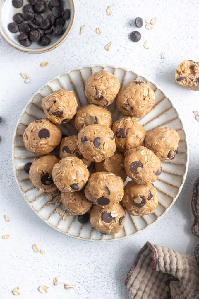 Soft and chewy peanut butter protein balls on a plate.