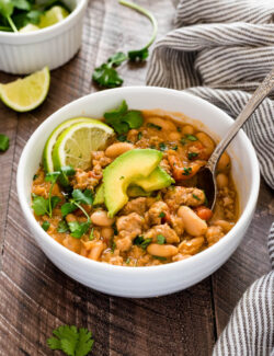 Spoon in bowl of white bean turkey chili.