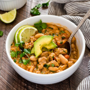 Spoon in bowl of white bean turkey chili.