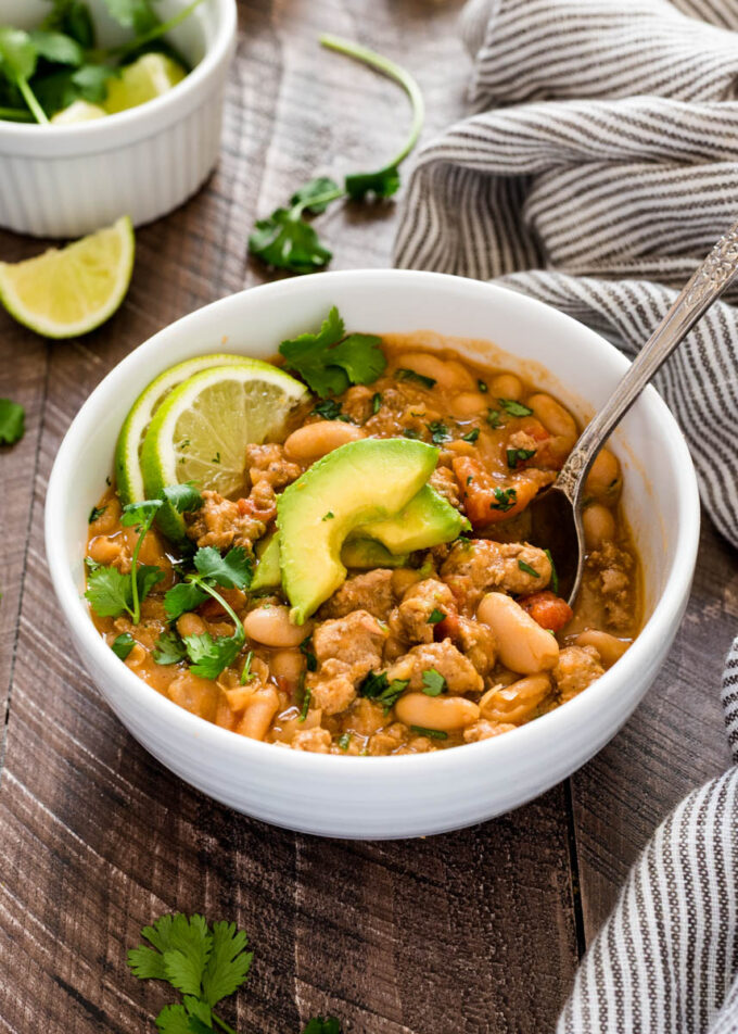Spoon in bowl of white bean turkey chili.