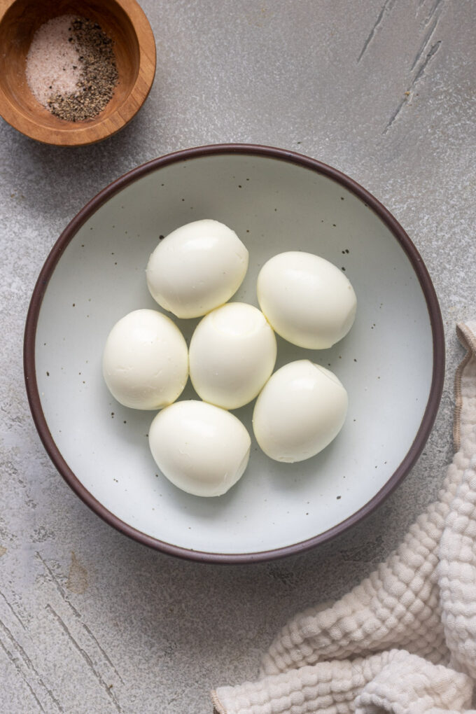 Peeled air fryer hard boiled eggs in a bowl.