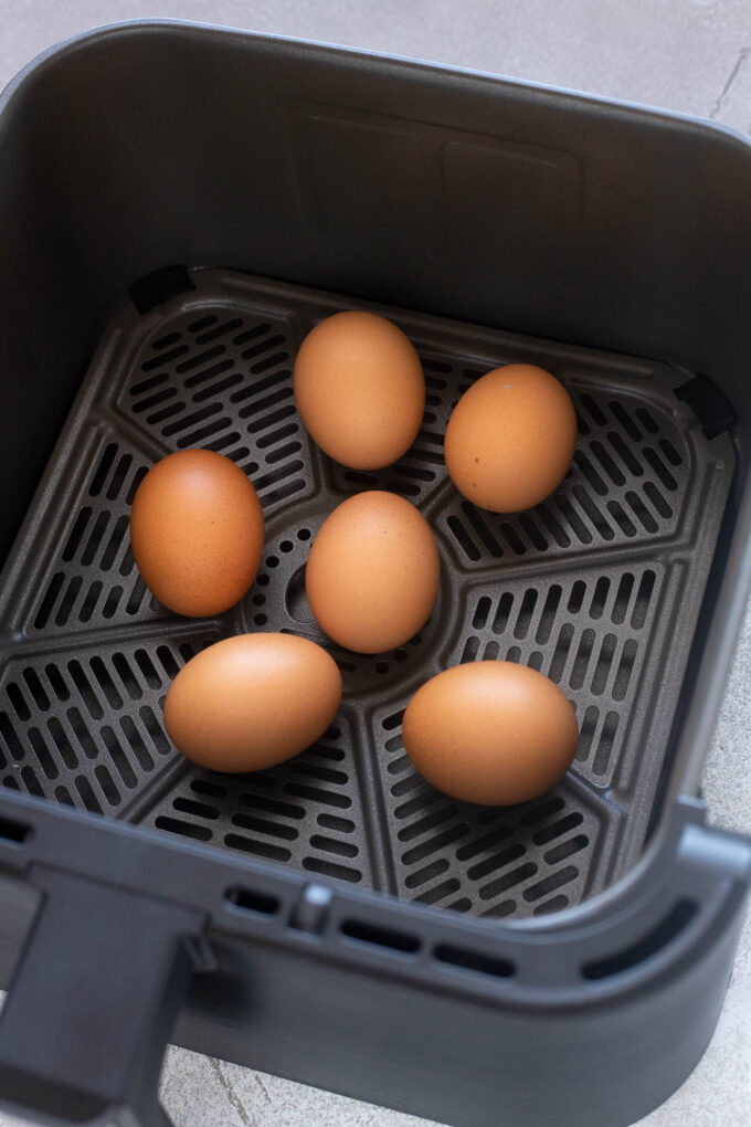 Hard boiled eggs in air fryer basket after cooking.