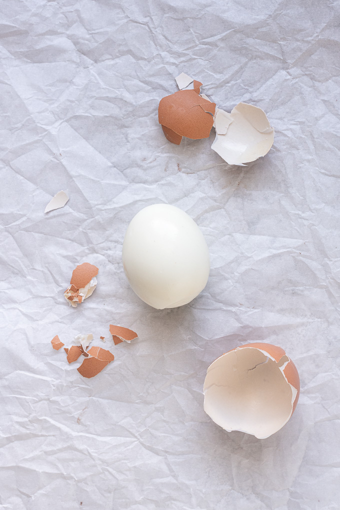 Peeled air fryer hard boiled eggs with large pieces of shell.