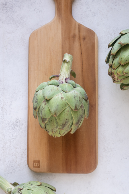 Remove the top of the artichoke stem.