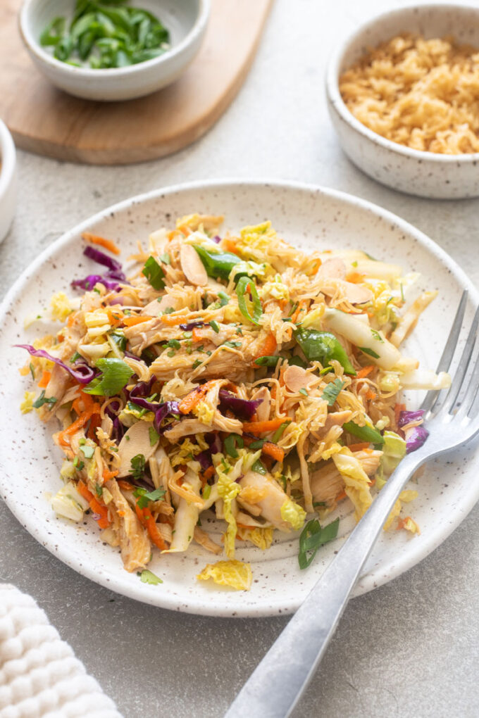 Serving of Chinese chicken salad topped with ramen noodles.