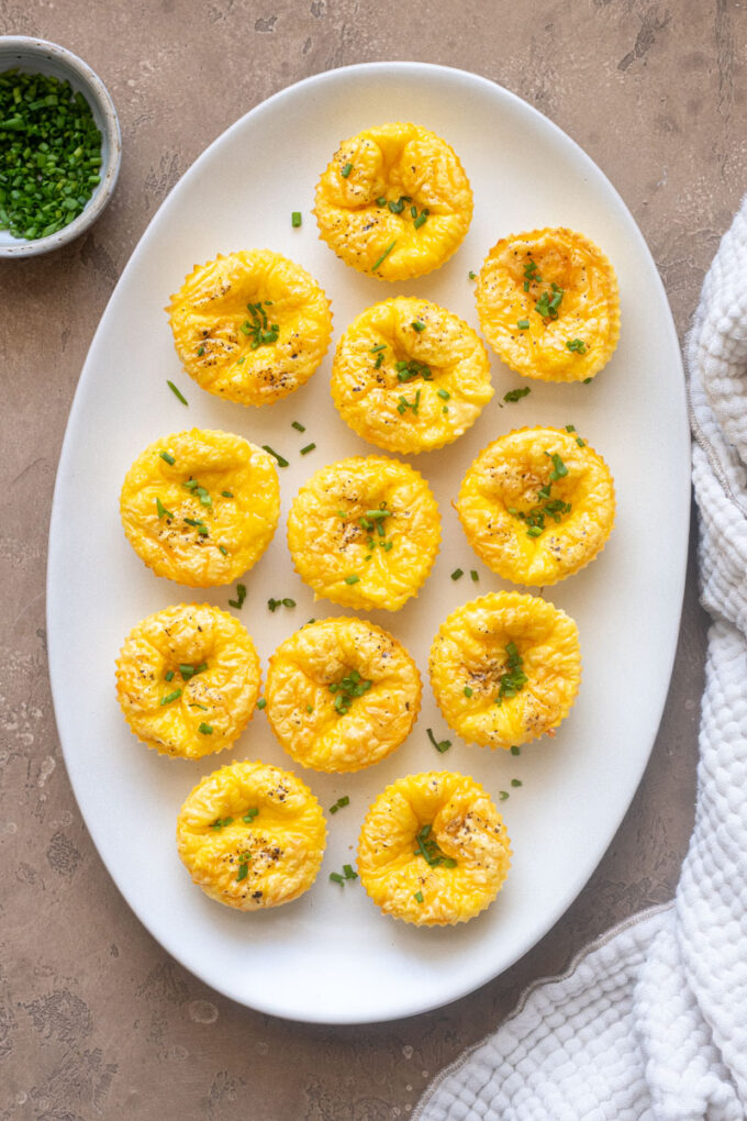 Cottage cheese egg bites on a platter topped with chives.