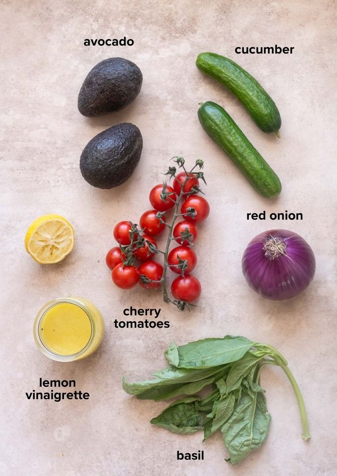 ingredients for cucumber tomato avocado salad with basil and lemon vinaigrette.