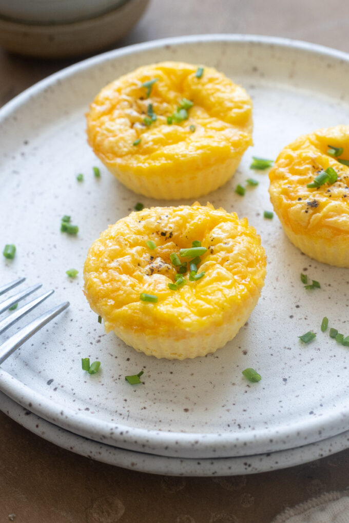 High protein cottage cheese egg bites on a plate with chives.