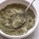 Homemade ranch seasoning in a bowl with spoon.