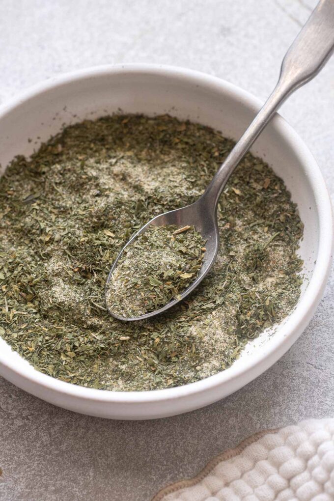 Homemade ranch seasoning in a bowl with spoon.