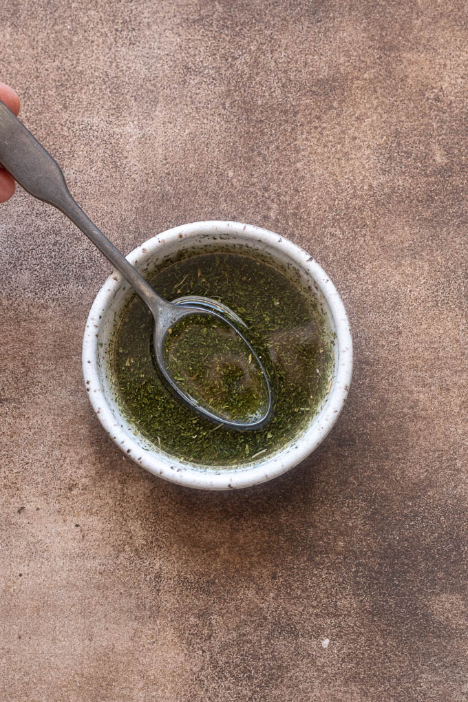 Olive oil, ranch seasoning, salt and pepper combined in a small bowl.