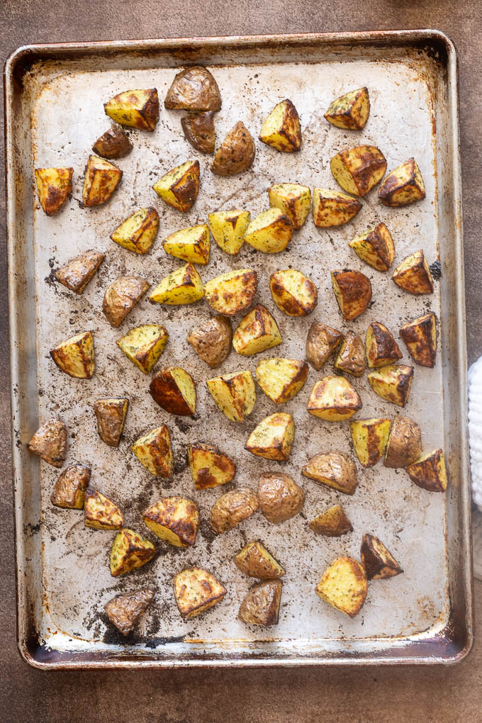 Crispy ranch roasted potatoes on a baking sheet.