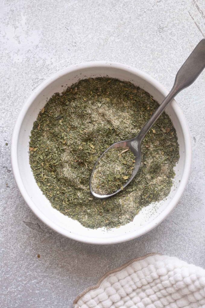 Overhead shot of ranch seasoning in bowl with spoon.