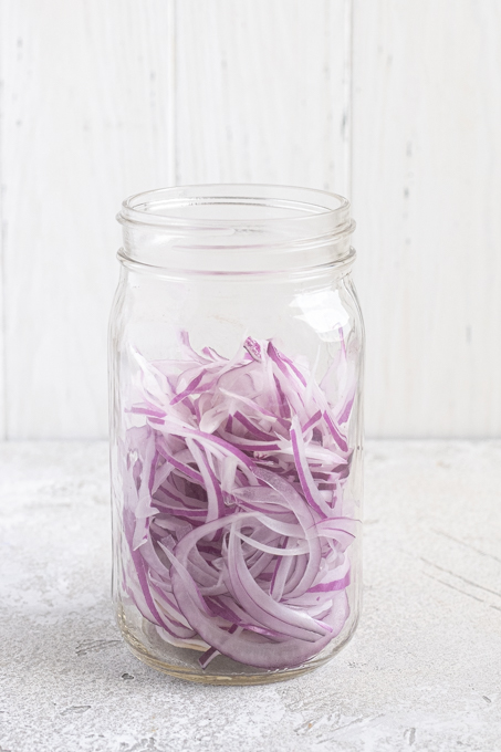 Sliced onions in a jar.