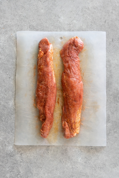 Pork tenderloins seasoned with spice rub.