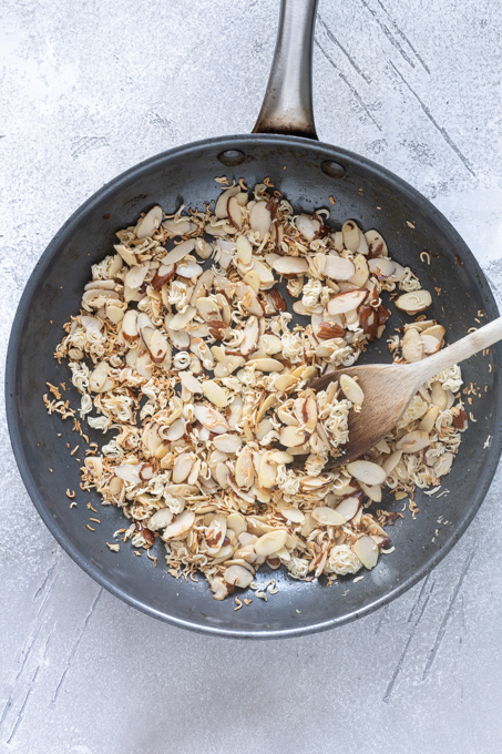 Toasted ramen noodles and almonds in a skillet.