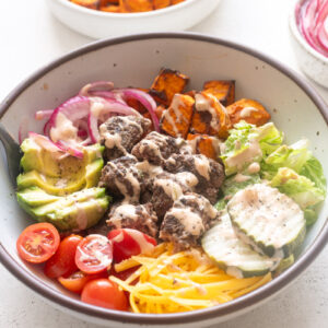 Easy burger bowls with burger sauce drizzled over the top.