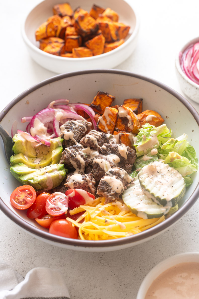 Easy burger bowls with burger sauce drizzled over the top.