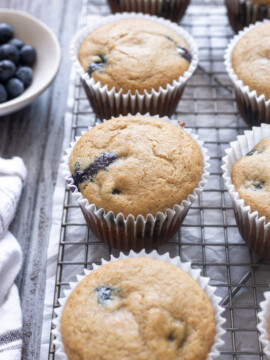 Blueberry Oat Flour Muffins on a wire rack.