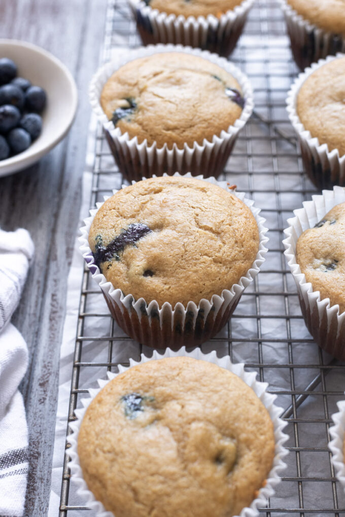 Blueberry Oat Flour Muffins on a wire rack.