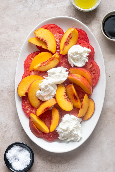 Heirloom tomatoes and peaches with creamy burrata on top.