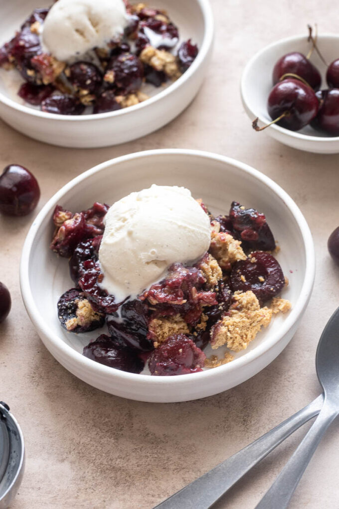 Easy fresh cherry crisp served warm with vanilla ice cream.